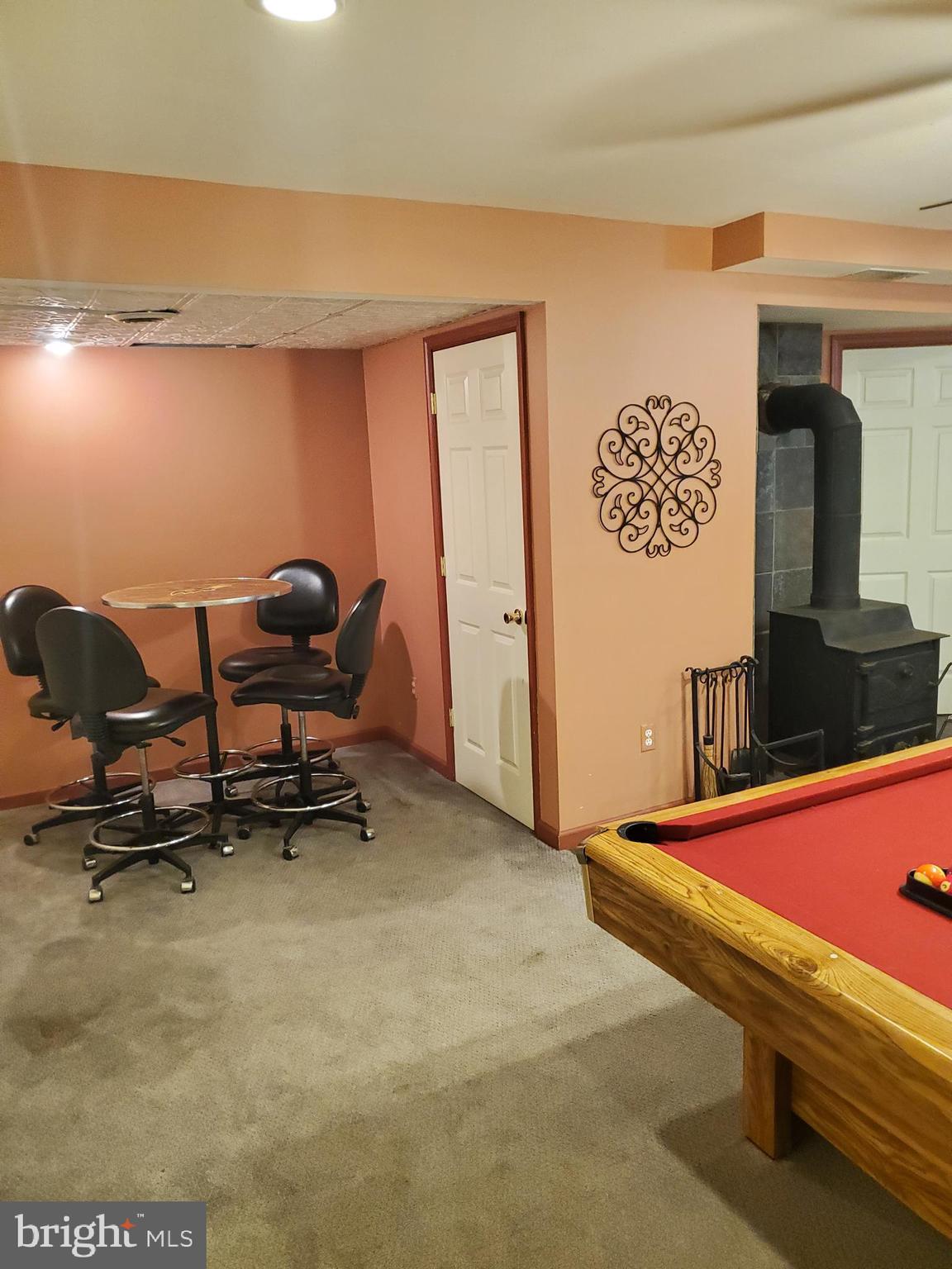 4515 Chestnut Ridge Drive Manchester, MD 21102 - Photo 39 of 47 Basement view of card table and wood burning stove