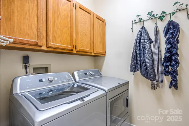 a view of a dining room with furniture wooden floor and a chandelier