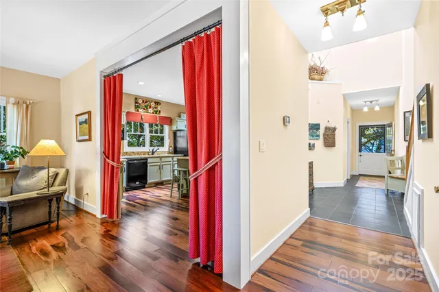 a living room with furniture fireplace and a large window