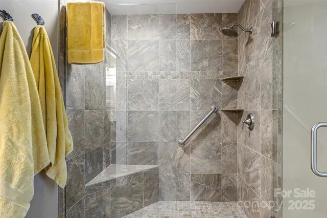 a spacious bedroom with a bed and wooden floor