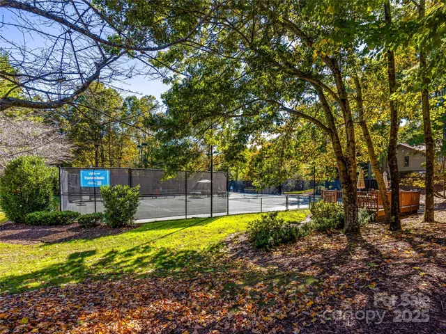 a front view of a house with a yard and tree s
