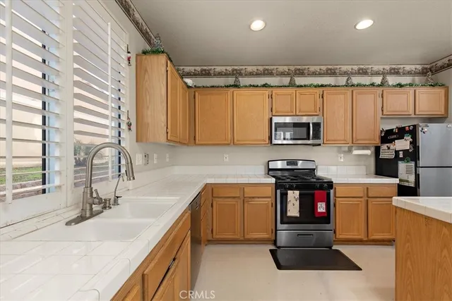 a kitchen with stainless steel appliances granite countertop a sink and a microwave
