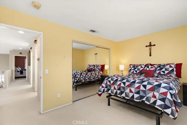 a bedroom with two beds and lamp