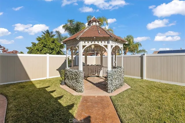 a view of a house with backyard porch and sitting area