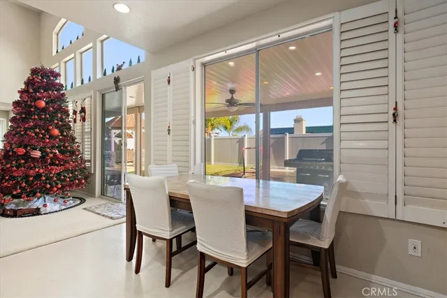 a view of a dining room with furniture and chandelier