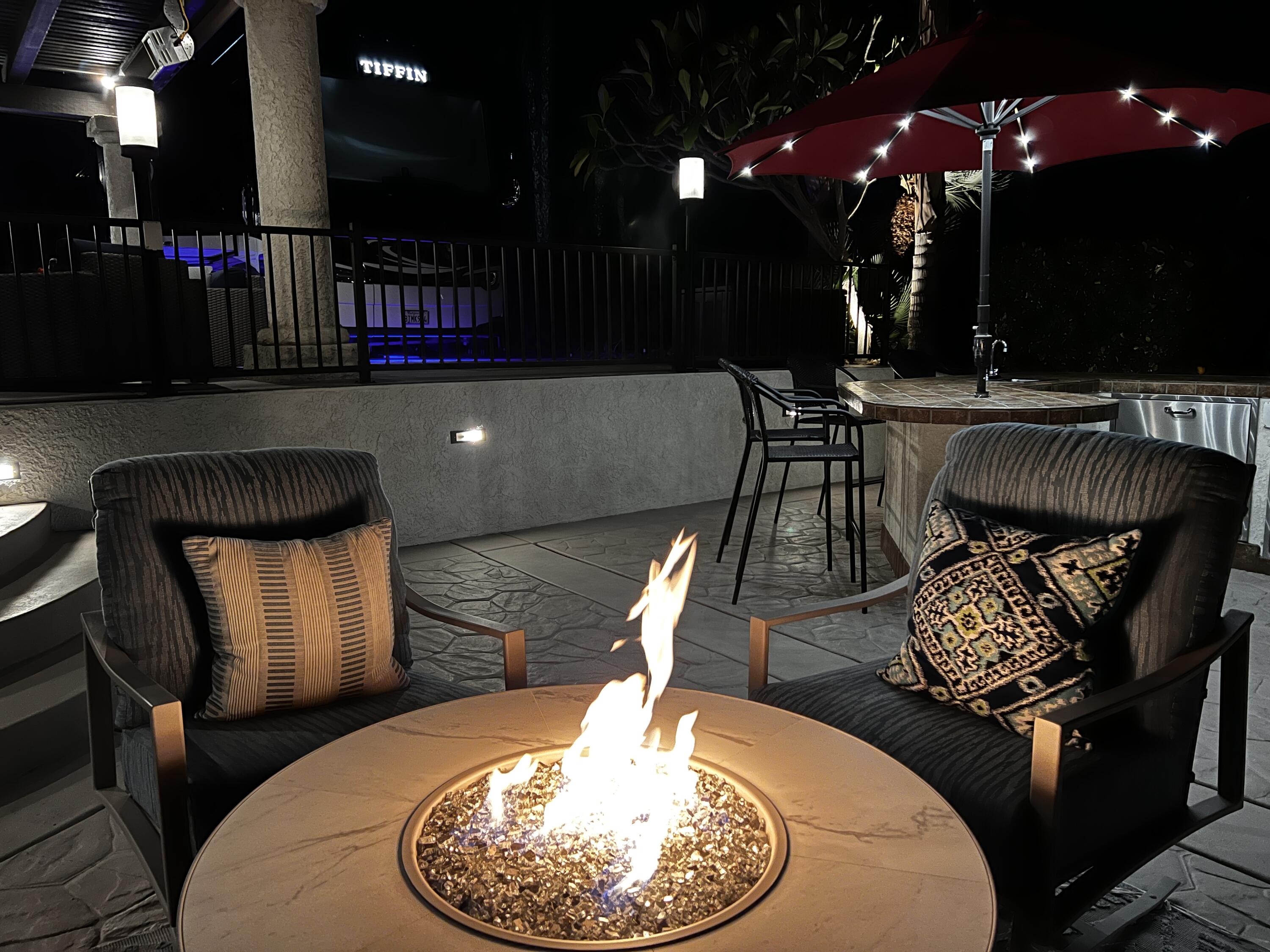 80501 Ave 48, Unit 110 Indio, CA 92201 - Photo 11 of 35 a living room with furniture a flat screen tv and kitchen view