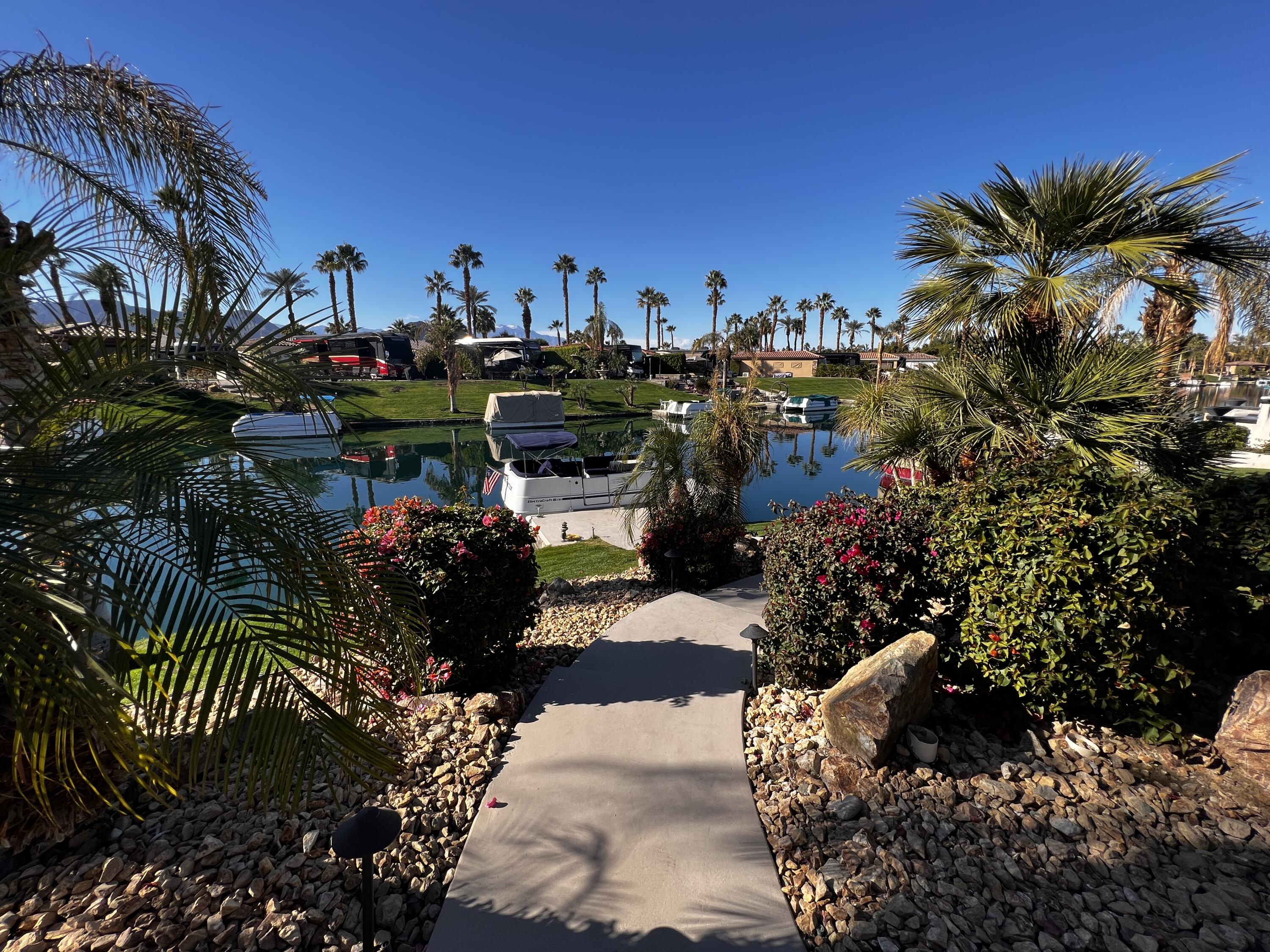 80501 Ave 48, Unit 110 Indio, CA 92201 - Photo 15 of 35 a view of a chairs and table in a backyard