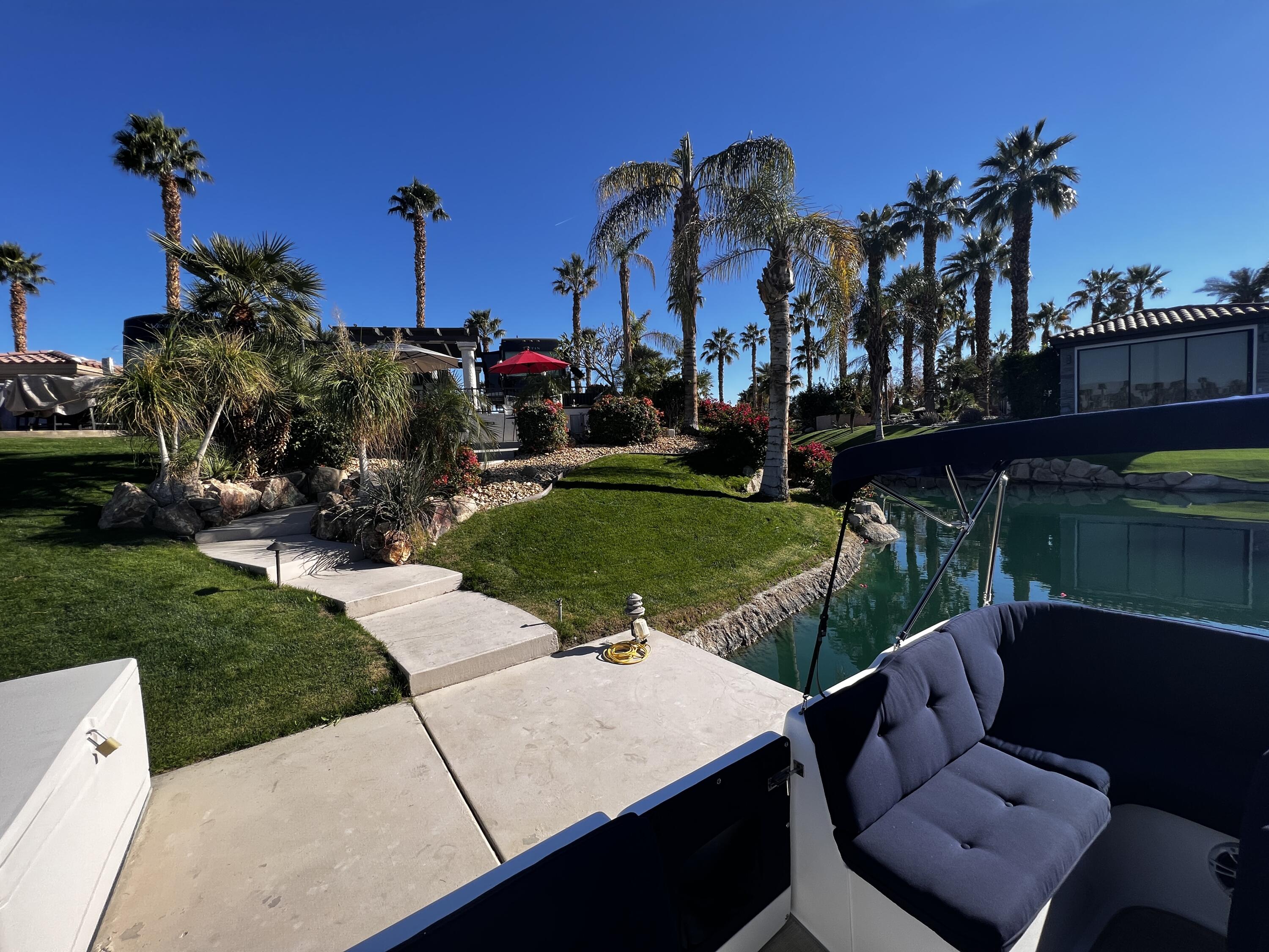 80501 Ave 48, Unit 110 Indio, CA 92201 - Photo 28 of 35 a view of a yard with plants and a table and chairs