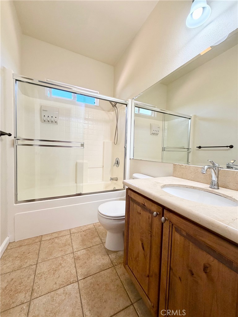 1037 Mark Twain Road Angels Camp, CA 95222 - Photo 32 of 52 a bathroom with a granite countertop sink mirror vanity and toilet