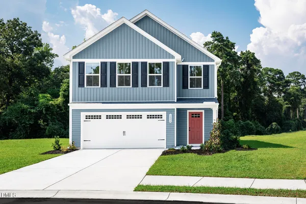 a view of a house with a yard and garage