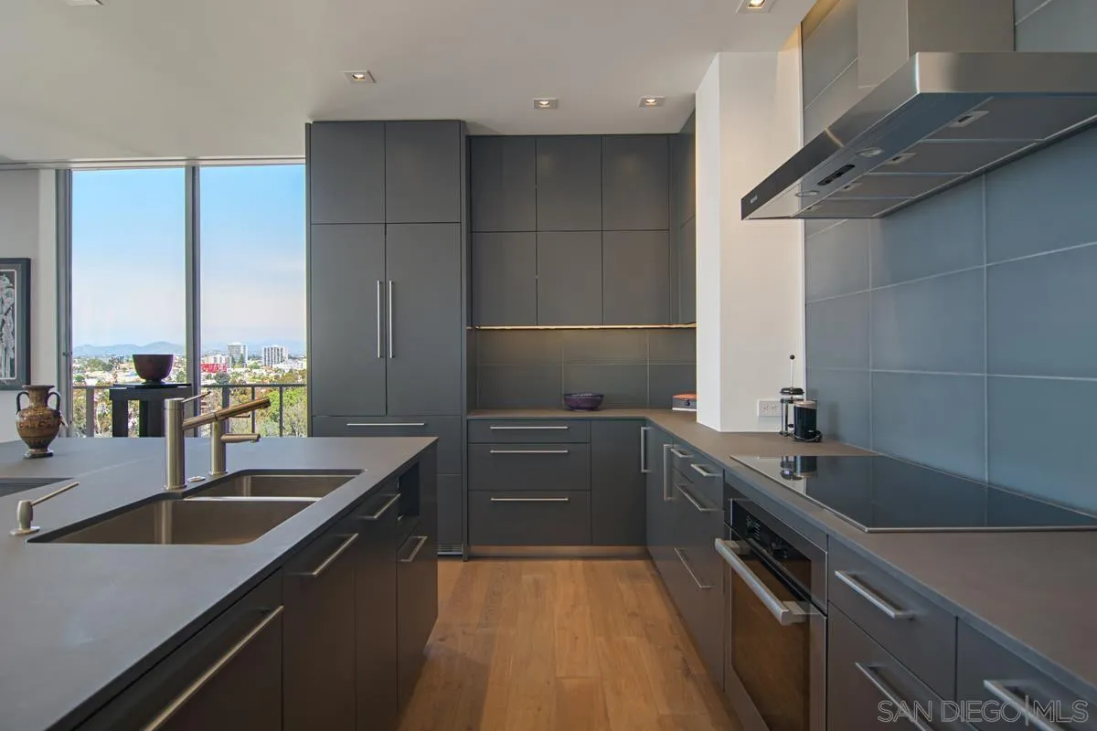 3634 7th Avenue, Unit 14H San Diego, CA 92103 - Photo 12 of 41 a kitchen with a sink stove and cabinets