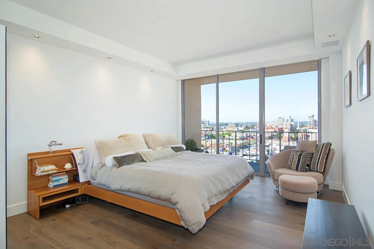 3634 7th Avenue, Unit 14H San Diego, CA 92103 - Photo 15 of 41 a bedroom with a bed and a couch next to a window