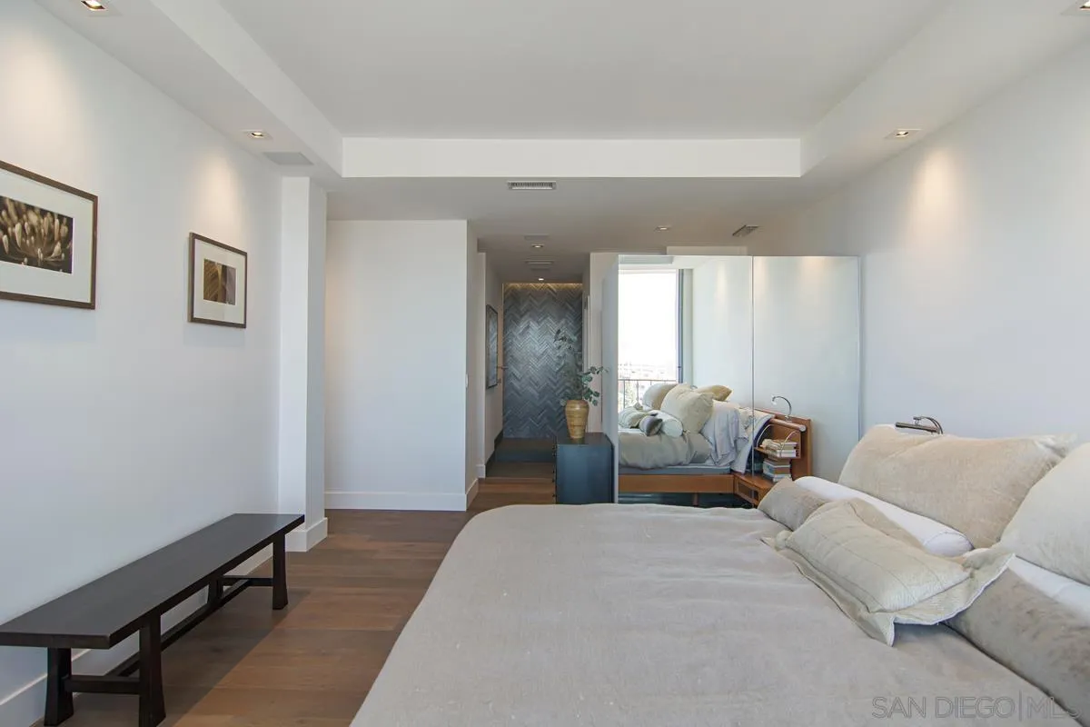 3634 7th Avenue, Unit 14H San Diego, CA 92103 - Photo 17 of 41 a bedroom with a bed and wooden floor