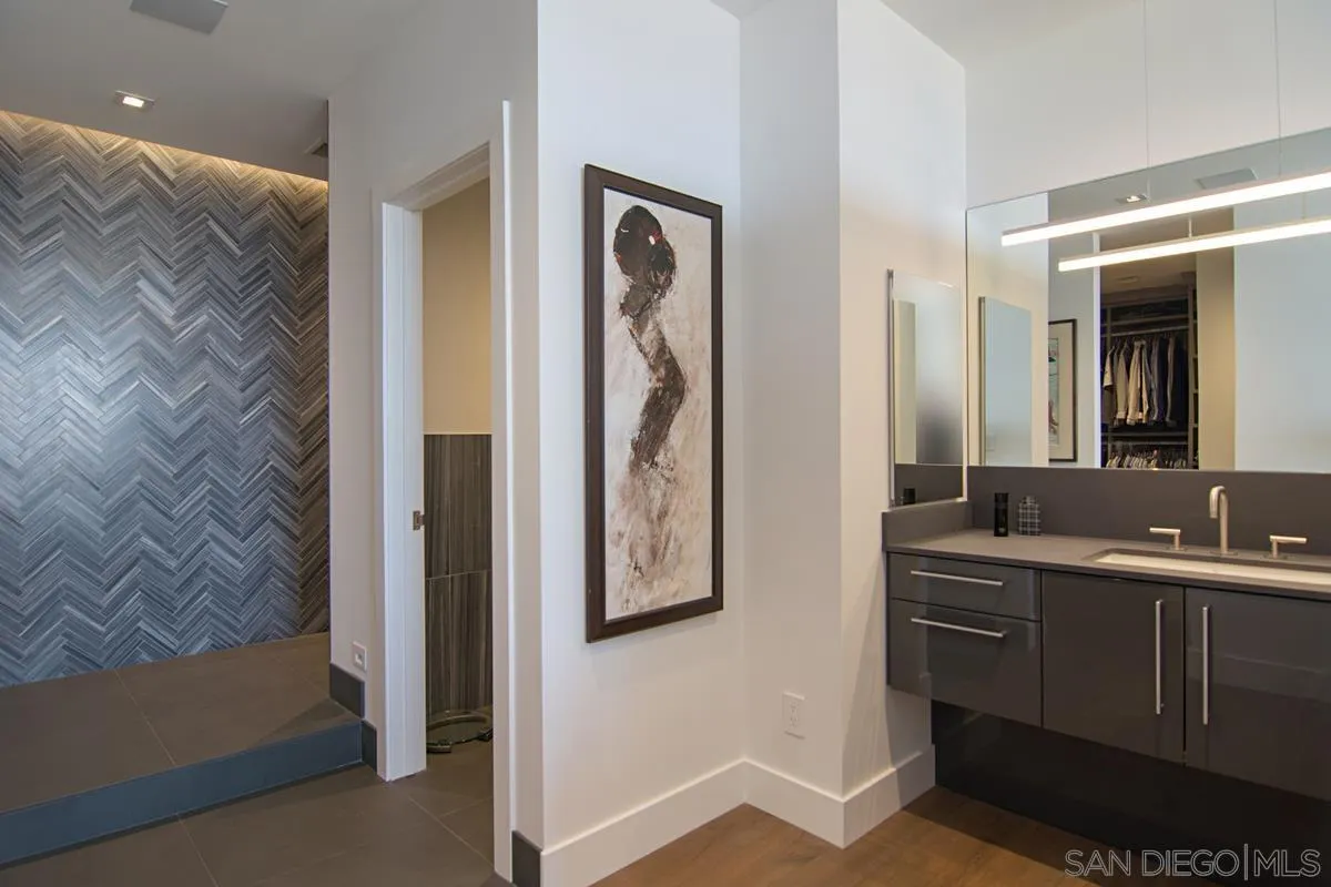 3634 7th Avenue, Unit 14H San Diego, CA 92103 - Photo 18 of 41 a en suite bathroom with a sink a mirror and a shower