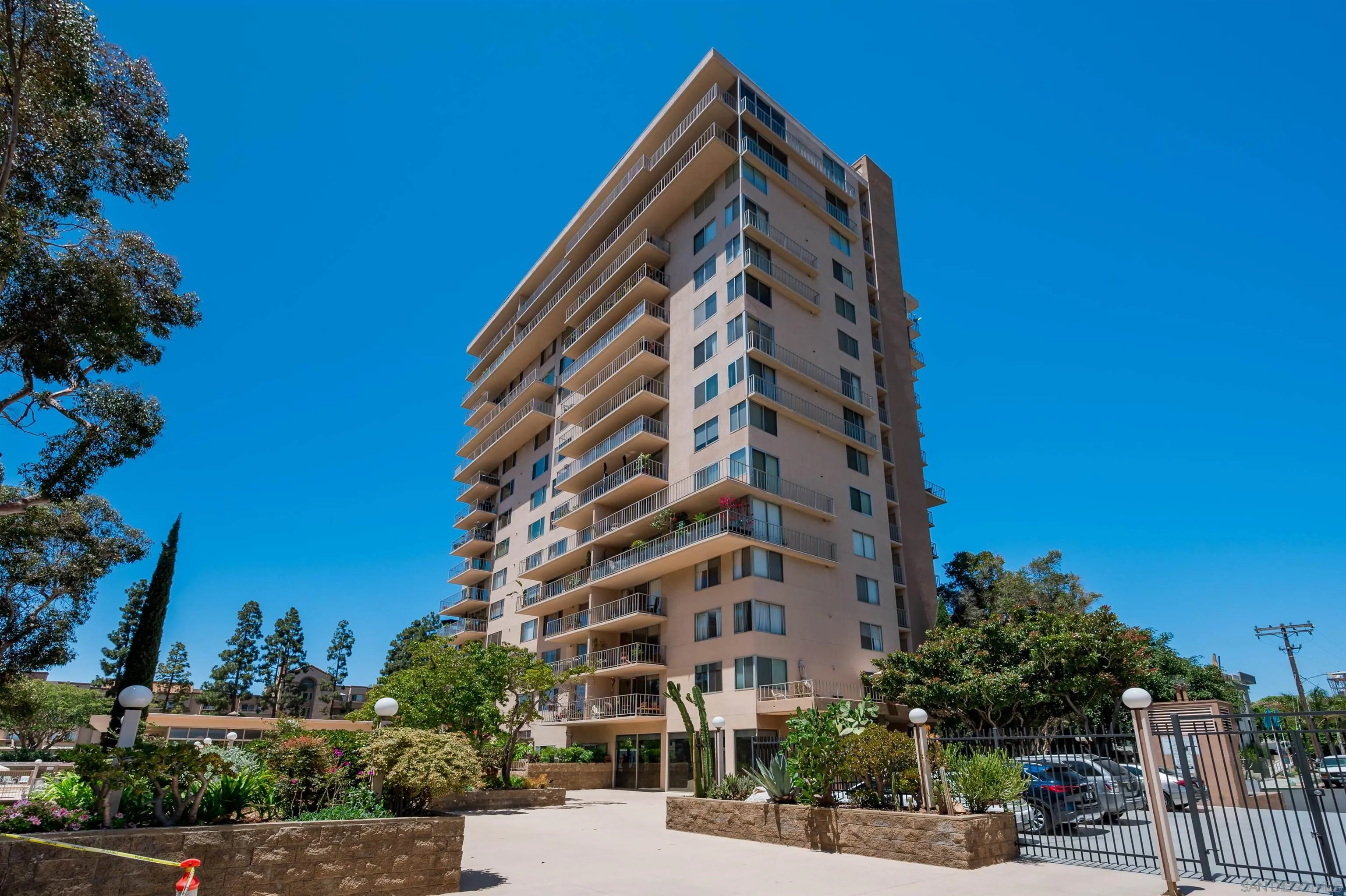 3634 7th Avenue, Unit 14H San Diego, CA 92103 - Photo 36 of 41 a view of a tall building next to a yard