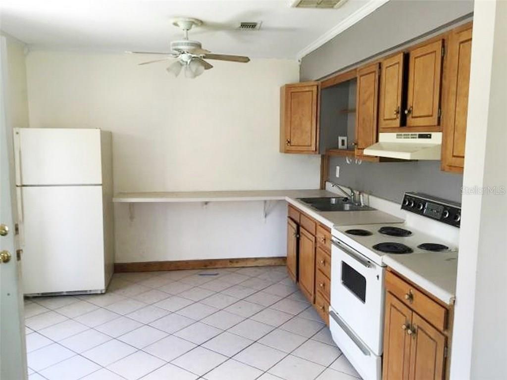1920 Trotter Road Largo, FL 33774 - Photo 7 of 19 a kitchen with a stove and a refrigerator