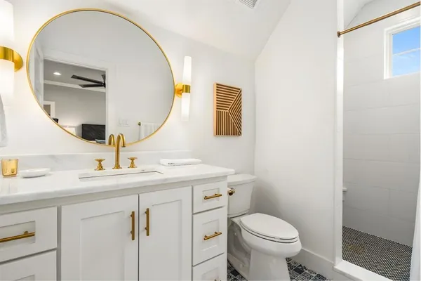 a bedroom with a bed couch and window