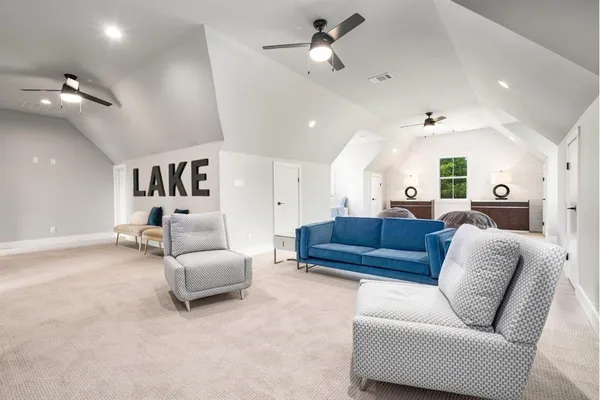 a living room with furniture and a ceiling fan