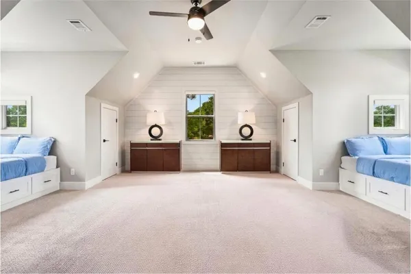 a living room with furniture and a ceiling fan