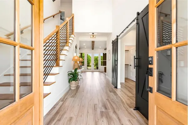 a view of a balcony with wooden floor and door