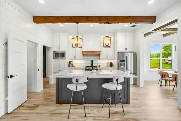 a open kitchen with stainless steel appliances granite countertop a stove and refrigerator