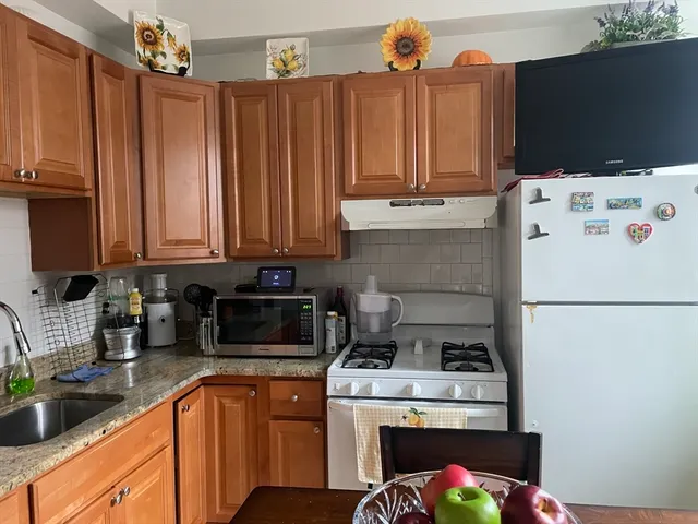 a kitchen with stainless steel appliances a stove a microwave and a refrigerator