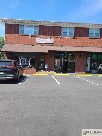 a view of a building with cars parked