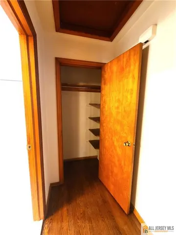 a view of walk in closet with empty room