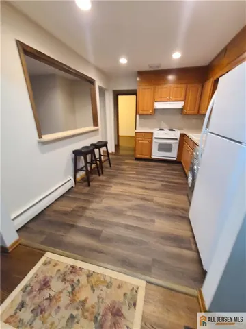 a view of kitchen with furniture and wooden floor