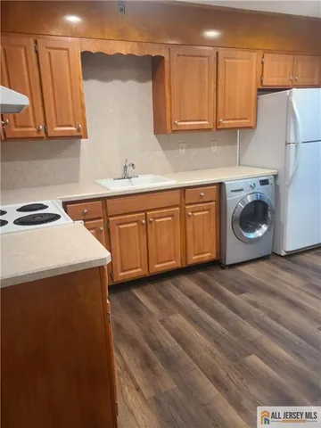 a kitchen with a sink a stove and cabinets