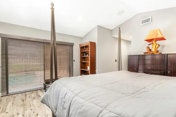 a bedroom with a large bed and a chandelier