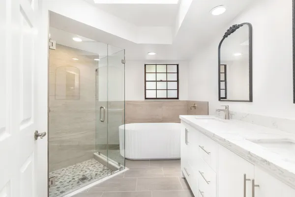 a bathroom with a sink a toilet and shower