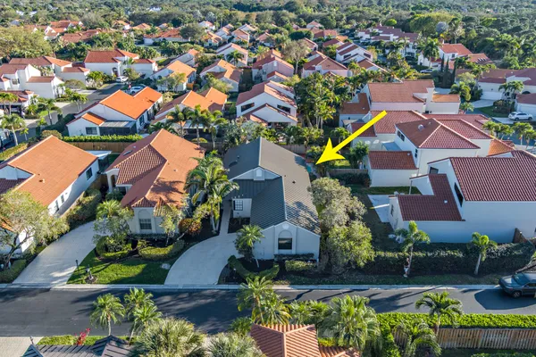 an aerial view of residential houses with outdoor space and swimming pool
