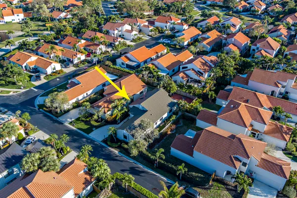 an aerial view of residential houses with outdoor space and street view