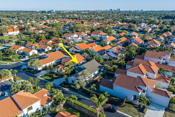 an aerial view of residential houses with outdoor space and parking