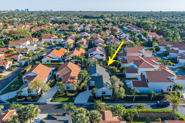 an aerial view of residential houses with outdoor space and swimming pool