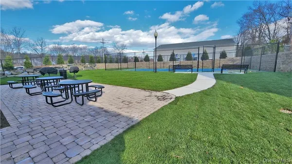 a view of a house with backyard and a sitting area