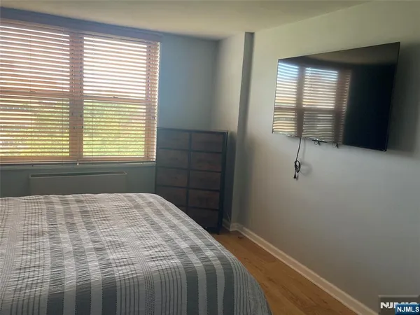 a bedroom with a bed and a cabinet