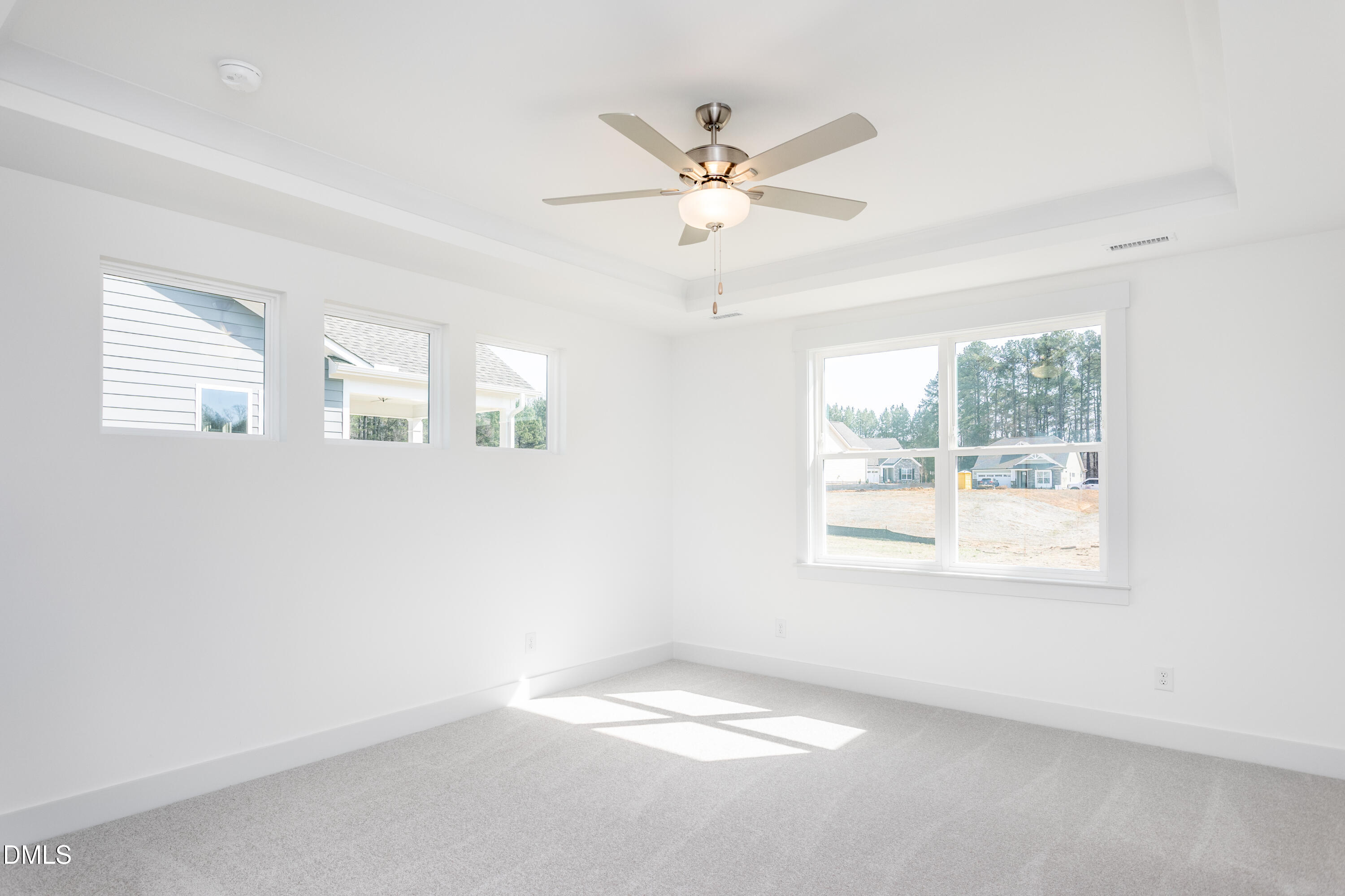 70 Slippery Elm Road Youngsville, NC 27596 - Photo 14 of 32 an empty room with windows and fan