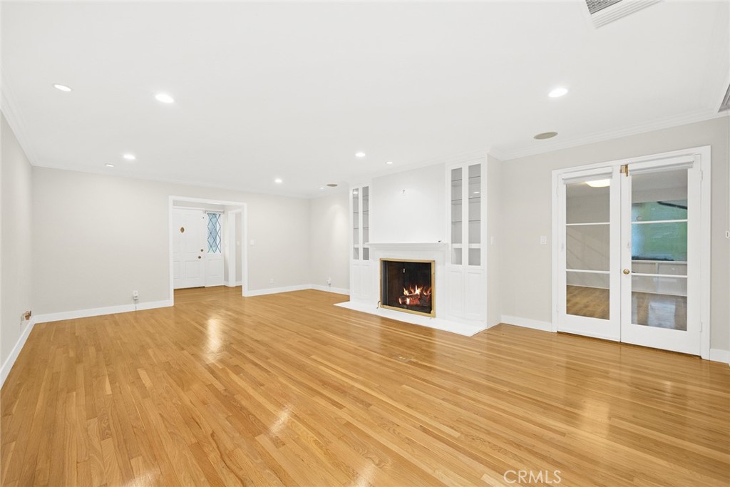 1300 Ramona Road Arcadia, CA 91006 - Photo 14 of 39 a view of an empty room with wooden floor and a fireplace