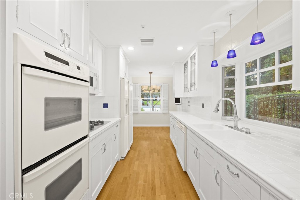 1300 Ramona Road Arcadia, CA 91006 - Photo 19 of 39 a large white kitchen with stainless steel appliances