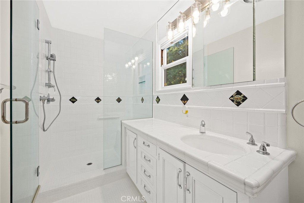 1300 Ramona Road Arcadia, CA 91006 - Photo 29 of 39 a bathroom with a double vanity sink a mirror and shower