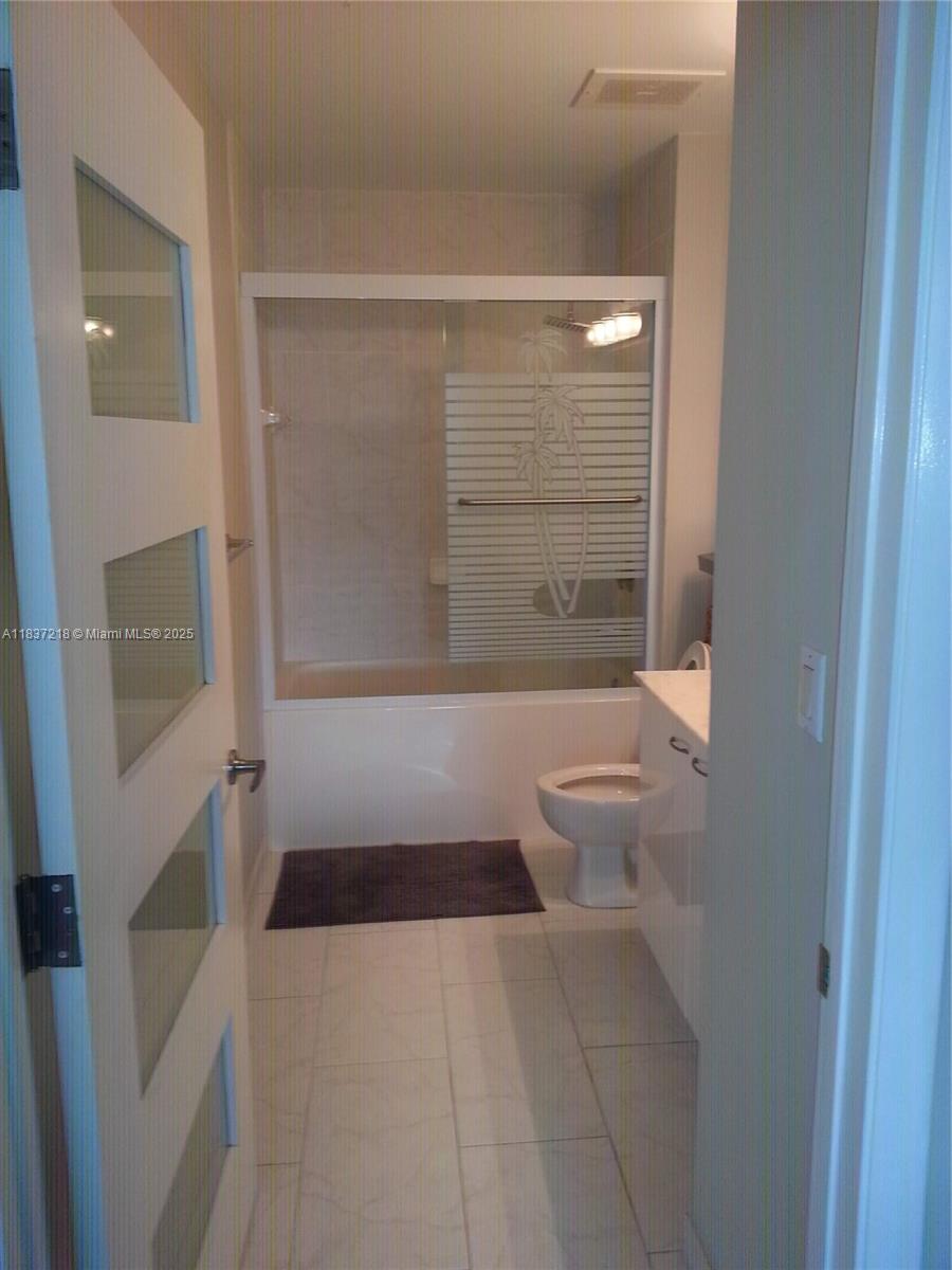 133 Northeast 2nd Avenue, Unit 412 Miami, FL 33132 - Photo 13 of 32 a bathroom with a bathtub and a shower