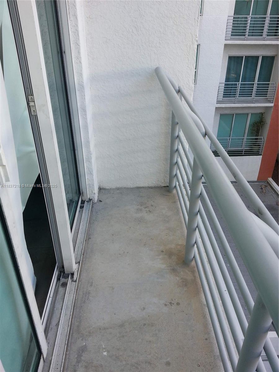 133 Northeast 2nd Avenue, Unit 412 Miami, FL 33132 - Photo 21 of 32 a view of an empty room with wooden floor