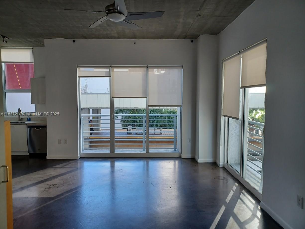 133 Northeast 2nd Avenue, Unit 412 Miami, FL 33132 - Photo 3 of 32 an empty room with wooden floor and windows