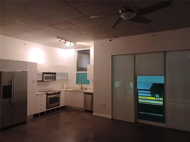 a kitchen with stainless steel appliances a stove a sink and a refrigerator