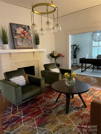 a living room with furniture a rug and a fireplace
