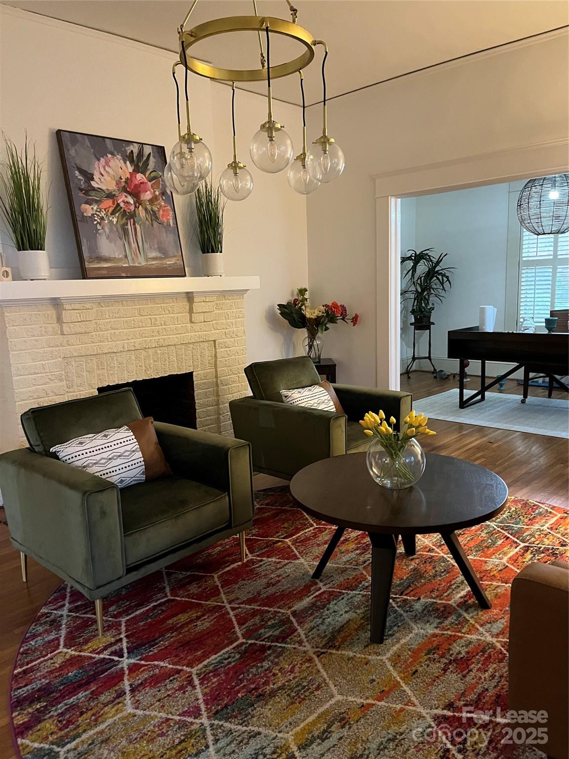 a living room with furniture a rug and a fireplace