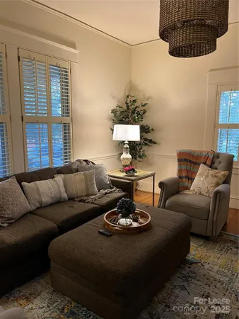 a living room with furniture a table and a window