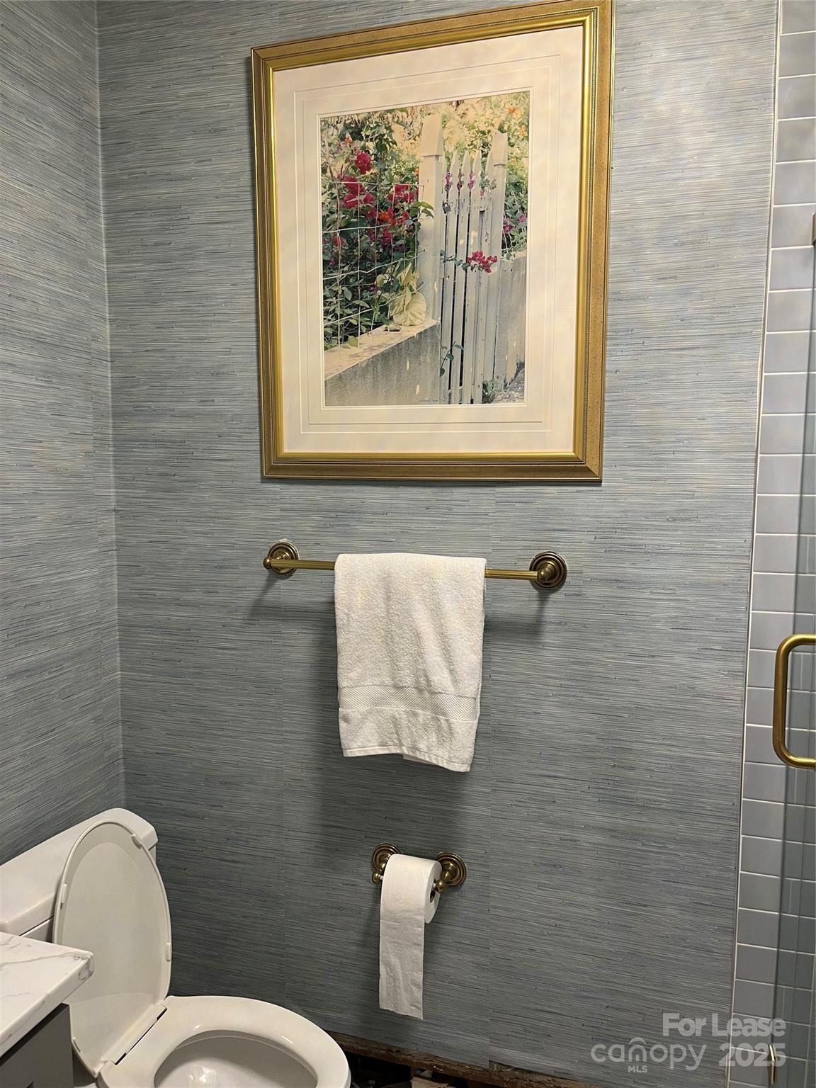 2615 Sharon Road Charlotte, NC 28211 - Photo 21 of 21 a bathroom with a toilet and a picture on the wall